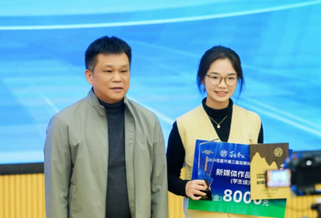 茂名市委网信办主任林国学(左)在为获奖者颁奖,并合影。