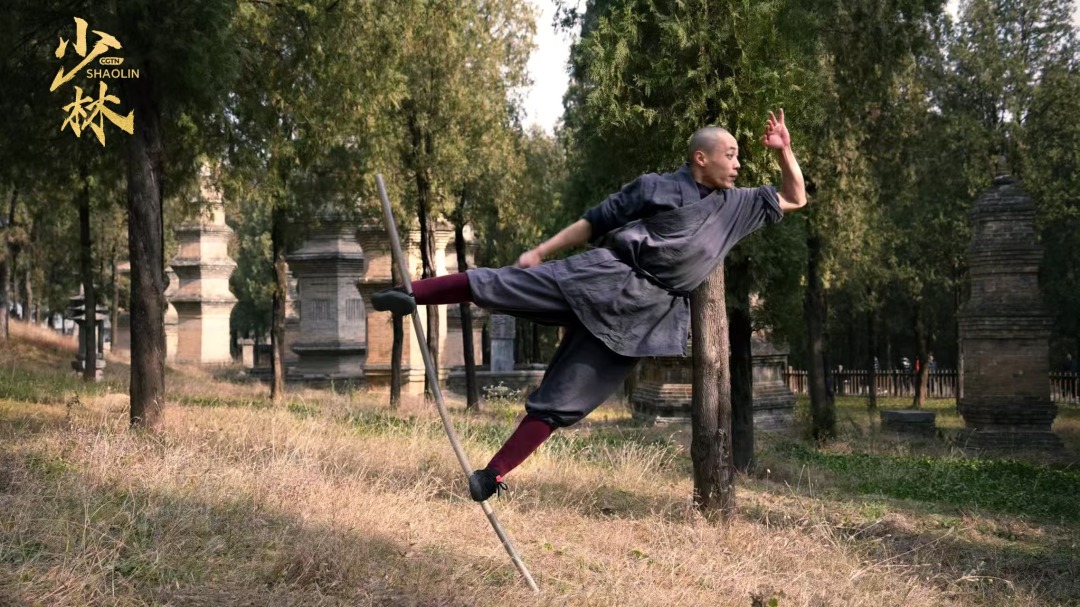 Shi stands on the Monkey Stick.