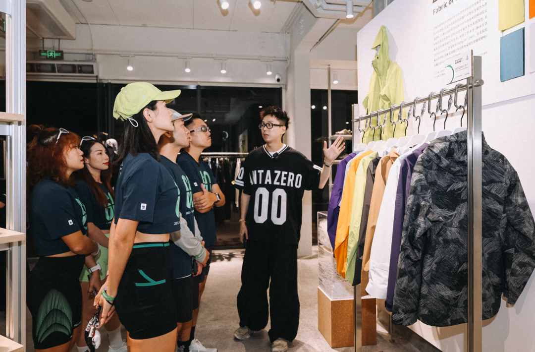 广州安踏0碳使命店店长向参与者介绍安踏环保面料