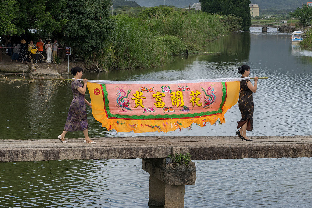 Tourists recreate a flag-lifting scene from 