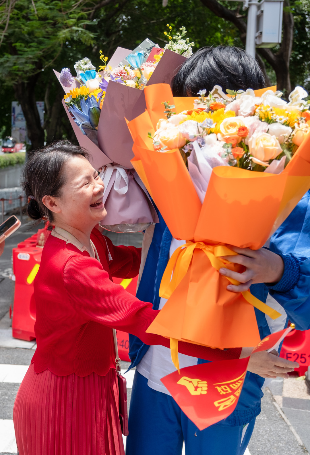 9日中午,华附考点,地理科目考试结束,家长鲜花迎接考生。图/广州日报新花城记者:庄小龙