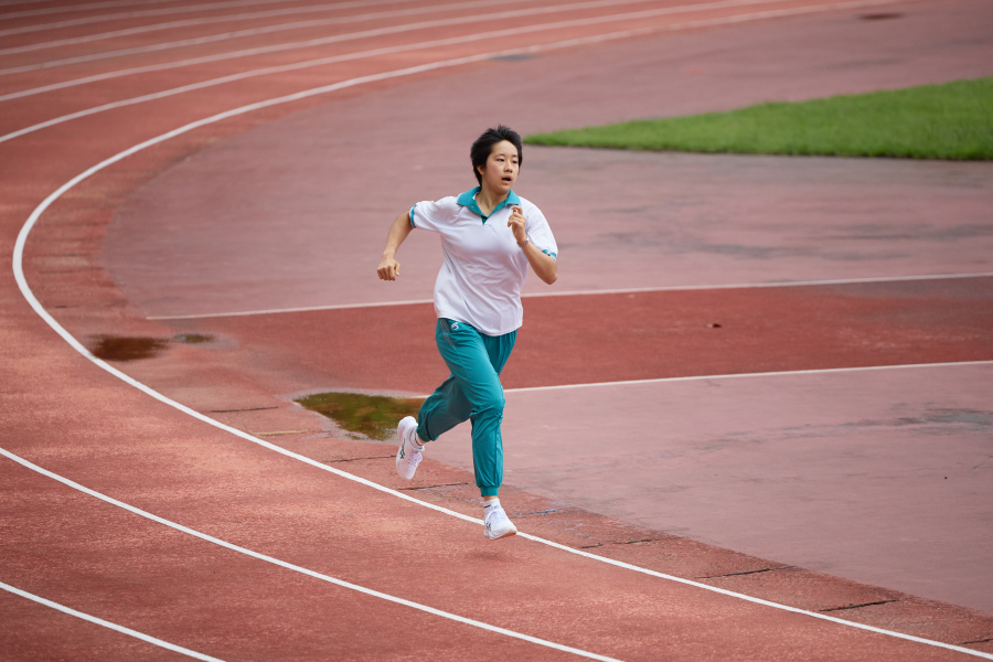 汤乐文在六中的田径场练习跑步。